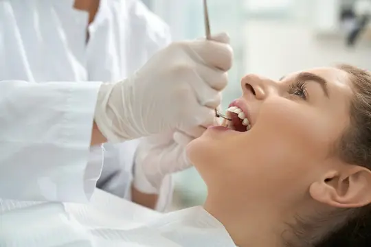 dentysta leczy zęby kobiecie